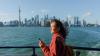 Woman on a boat with Canada skyline behind her